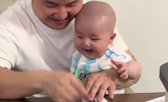 宝宝被爸爸逗笑 笑容超有感染力