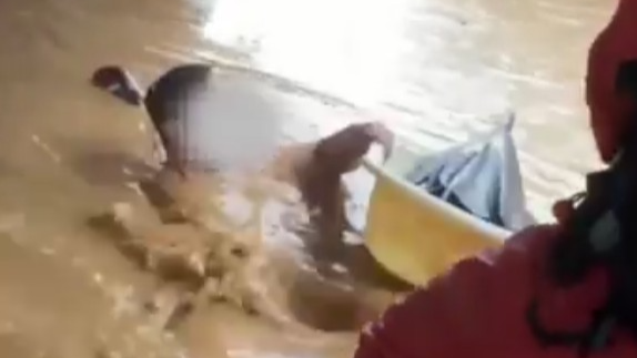洪水中一男子紧抱澡盆漂流被消防员奋力救起